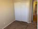Bedroom with carpeted floors and a closet featuring sliding doors at 4533 E Glenhaven Dr, Phoenix, AZ 85048