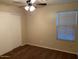 Bedroom featuring ceiling fan, closet with sliding door, and a window at 4533 E Glenhaven Dr, Phoenix, AZ 85048