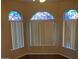 Bright bedroom featuring stained glass windows and modern window coverings at 4533 E Glenhaven Dr, Phoenix, AZ 85048