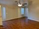Spacious living room featuring hardwood floors, a ceiling fan, and plenty of natural light at 4533 E Glenhaven Dr, Phoenix, AZ 85048