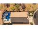 Aerial view of home showcases a backyard oasis with a pool, hot tub, and meticulous landscaping in a desert setting at 4605 E Swilling Rd, Phoenix, AZ 85050