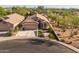 Expansive aerial view of a home surrounded by lush desert landscaping with neighborhood and mountains in the distance at 4605 E Swilling Rd, Phoenix, AZ 85050