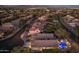 Striking aerial view of a home in an illuminated desert community, showcasing the pool and well-lit streets at 4605 E Swilling Rd, Phoenix, AZ 85050