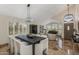 Bright dining room with modern chandelier, large table, shutters, piano and elegant finishes at 4605 E Swilling Rd, Phoenix, AZ 85050