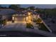 Elegant single Gathering home with a three-car garage, enhanced by meticulous landscaping and warm exterior lighting at 4605 E Swilling Rd, Phoenix, AZ 85050