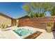 A modern hot tub is nestled in a private outdoor space with a stylish wood and metal fence and manicured landscaping at 4605 E Swilling Rd, Phoenix, AZ 85050