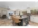 Open concept kitchen with island seating, stainless appliances, bright windows, and bar stools at 4605 E Swilling Rd, Phoenix, AZ 85050
