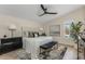 Well-lit main bedroom featuring a modern ceiling fan, elegant decor, and a window with lots of natural light at 4605 E Swilling Rd, Phoenix, AZ 85050