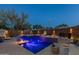 Stunning pool area with multiple fire features, a luxurious spa, and elegant landscaping at 4605 E Swilling Rd, Phoenix, AZ 85050