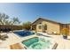 Backyard pool and jacuzzi with beautiful tile, outdoor lounge chairs, and manicured desert landscaping at 4605 E Swilling Rd, Phoenix, AZ 85050