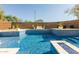 Stunning pool area featuring a mosaic-tiled surface, a built-in hot tub, and an inviting seating area for relaxation at 4605 E Swilling Rd, Phoenix, AZ 85050