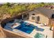 Stunning backyard pool with a spa, sunbathing area, outdoor seating, and outdoor kitchen perfect for entertaining and relaxation at 4605 E Swilling Rd, Phoenix, AZ 85050
