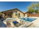 Backyard featuring a blue tiled swimming pool and spa with outdoor lounge chairs at 4605 E Swilling Rd, Phoenix, AZ 85050