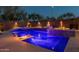 Stunning backyard pool features vibrant blue lighting, a modern privacy fence, and stylish landscaping at 4605 E Swilling Rd, Phoenix, AZ 85050