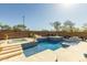 A lavish pool area complete with a built-in hot tub, a cozy seating area, and a shimmering mosaic-tiled pool surface at 4605 E Swilling Rd, Phoenix, AZ 85050