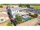 Aerial view of a large two-story home with a backyard pool, patio, and well-maintained landscaping at 5212 S Seton Ct, Gilbert, AZ 85298