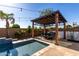 A gazebo sits on the edge of the pool in this lovely backyard at 5212 S Seton Ct, Gilbert, AZ 85298