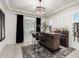 Chic home bar with a modern chandelier, dark curtains, and well-stocked shelves for entertaining guests at 5212 S Seton Ct, Gilbert, AZ 85298