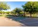 Full basketball court in a beautifully maintained community park with trees and landscaping at 5212 S Seton Ct, Gilbert, AZ 85298