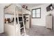 Modern bedroom loft features a full bed with a ladder, desk and drawers, with neutral carpet at 5212 S Seton Ct, Gilbert, AZ 85298