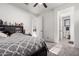 Cozy bedroom with neutral carpet, large bed, with an adjacent bathroom and walk-in closet at 5212 S Seton Ct, Gilbert, AZ 85298