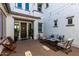 Inviting courtyard with stylish outdoor seating, string lights, and a beautifully crafted wooden front door at 5212 S Seton Ct, Gilbert, AZ 85298