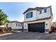 Impressive two-story home with a dark brown multi-car garage and a white exterior with elegant stone accents at 5212 S Seton Ct, Gilbert, AZ 85298