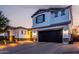 Beautiful two-story home with a dark garage door, stucco siding, stone accents, and manicured desert landscaping at 5212 S Seton Ct, Gilbert, AZ 85298