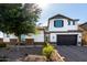 Charming two-story home featuring stone accents, a two car garage, and desert landscaping at 5212 S Seton Ct, Gilbert, AZ 85298