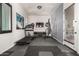 Well-equipped home gym with a treadmill, punching bag, and TV for a complete fitness experience at 5212 S Seton Ct, Gilbert, AZ 85298