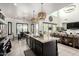 Open-concept kitchen boasts a large island, stainless appliances, and a seamless flow to the dining and living areas at 5212 S Seton Ct, Gilbert, AZ 85298