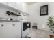 This laundry room features modern appliances, cabinetry, and a pet door at 5212 S Seton Ct, Gilbert, AZ 85298