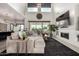 Open concept living room featuring a fireplace, high ceilings, and seamless connection to the kitchen at 5212 S Seton Ct, Gilbert, AZ 85298