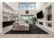 Spacious living room featuring a modern fireplace, soaring ceilings, and large sliding glass doors to the backyard at 5212 S Seton Ct, Gilbert, AZ 85298