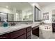 This main bathroom features double sinks, granite countertops and a mosaic backsplash at 5212 S Seton Ct, Gilbert, AZ 85298
