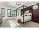 This bright main bedroom has a four poster bed, a ceiling fan, and plantation shutters at 5212 S Seton Ct, Gilbert, AZ 85298