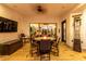 Covered outdoor patio featuring a fire pit with table, seating, and outdoor tv at 5212 S Seton Ct, Gilbert, AZ 85298