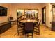 Covered outdoor patio with a table, chairs, fire pit and mounted television for entertaining at 5212 S Seton Ct, Gilbert, AZ 85298