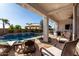 An expansive covered patio with ample seating and a view of the stunning backyard pool at 5212 S Seton Ct, Gilbert, AZ 85298