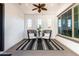 Stylish covered patio with ceiling fan, modern chairs, and serene natural lighting at 5212 S Seton Ct, Gilbert, AZ 85298