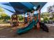 Attractive community playground with climbing structures, slide, and soft landing surface at 5212 S Seton Ct, Gilbert, AZ 85298