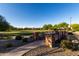 Scenic view of the community pond with a charming walking bridge and landscaped surroundings at 5212 S Seton Ct, Gilbert, AZ 85298
