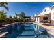 Inviting backyard pool with cascading waterfall feature, pergola, and patio under string lights at 5212 S Seton Ct, Gilbert, AZ 85298