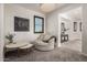 This sitting room features a comfortable chair, built-in shelving and plantation shutters at 5212 S Seton Ct, Gilbert, AZ 85298