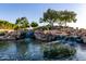 Picturesque community water feature with natural rock formations and lush landscaping providing a relaxing environment at 5212 S Seton Ct, Gilbert, AZ 85298