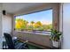 Enjoy the view from the condo balcony, complete with seating and a lush landscape at 5345 E Van Buren St # 307, Phoenix, AZ 85008