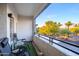 Balcony with seating offering views of palm trees, landscaping and the street at 5345 E Van Buren St # 307, Phoenix, AZ 85008
