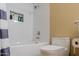 A bright bathroom with a white tile shower, modern toilet, and built-in shower niche at 5345 E Van Buren St # 307, Phoenix, AZ 85008