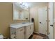 Bathroom with white vanity, marble countertop, a framed mirror and a warm, neutral wall color at 5345 E Van Buren St # 307, Phoenix, AZ 85008
