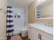 A well-lit bathroom featuring a shower-tub combo, modern fixtures, and a stylish vanity at 5345 E Van Buren St # 307, Phoenix, AZ 85008